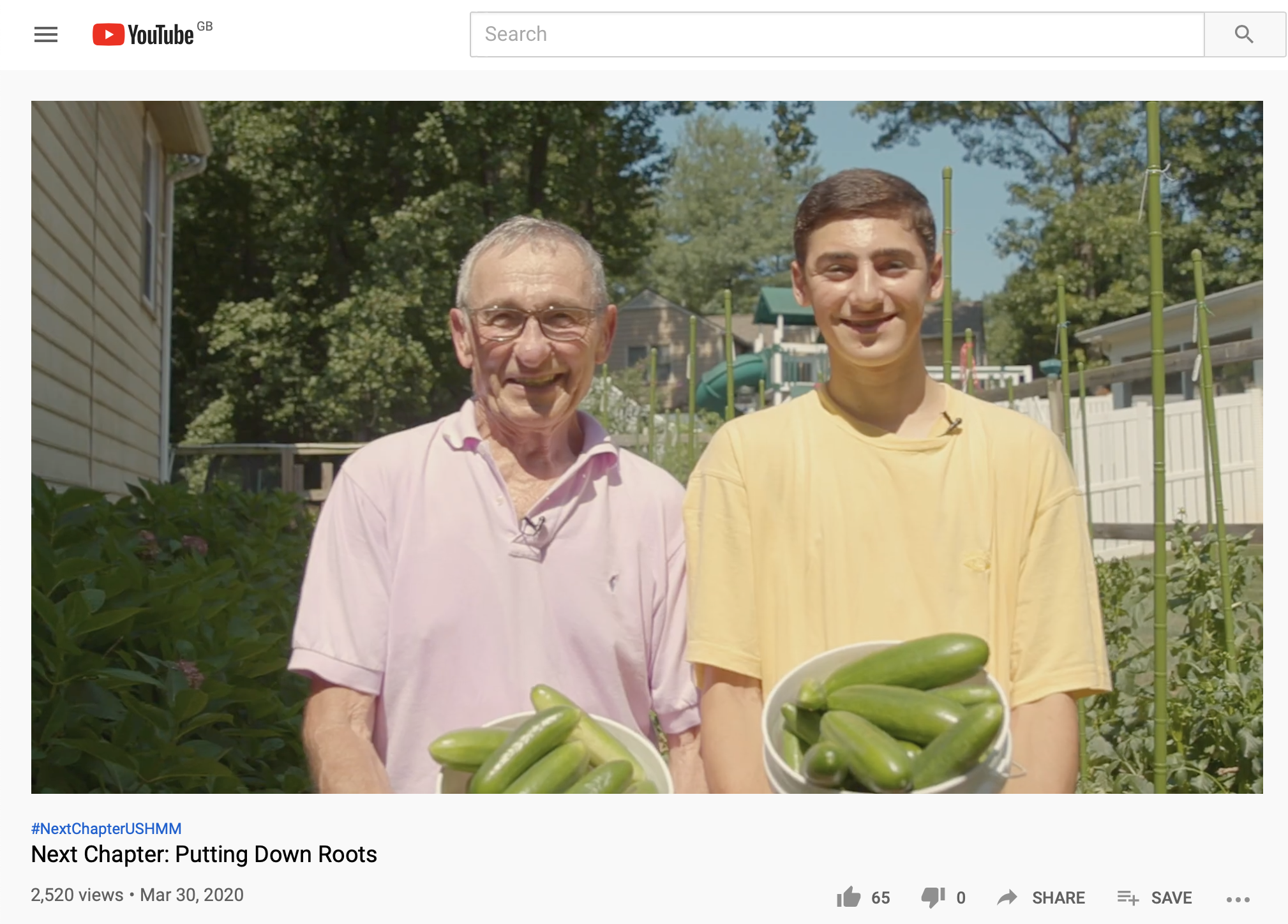 Nat Shaffir and his grandson holding their harvest of cucumbers