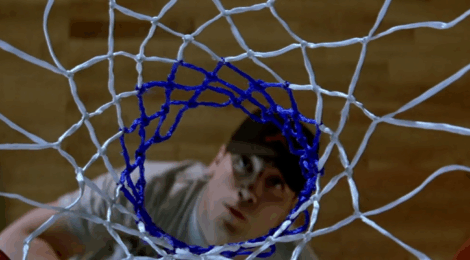 a man seen from above and through a basket ball net